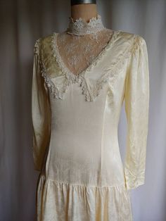 "Beautiful Victorian wedding dress with a dropped waist Silky smooth fabric Lace high collar Back zipper Label - Gunne Sax Size 11 Bust - 36\" Waist - 30\" Hips - 40\" Back - 14\" Sleeve - 21\" Length - 48\" Excellent vintage condition Gently washed and steamed" Fitted Lace Trim Wedding Dress, Fitted Wedding Dress With Lace Collar, Fitted Bias Cut Wedding Dress, Vintage Wedding Gown With Bias Cut, Cream Fitted Wedding Dress With Lace Trim, Fitted Cream Bias Cut Gown, Fitted Cream Wedding Dress, Victorian Wedding Dress, Wedding Dress Lace