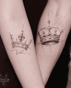 two people with matching tattoos on their arms holding hands and one is wearing a crown