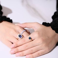 two women's hands with rings on their fingers