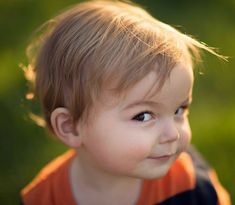 a little boy that is looking at the camera