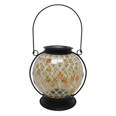 a decorative glass lantern on a stand with a black handle and an intricate mosaic design