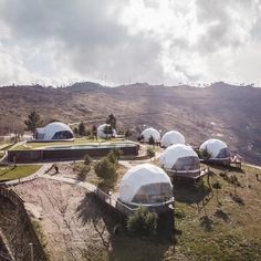 an aerial view of several domes on top of a hill