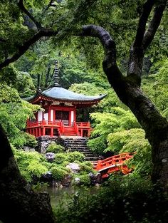 a red building surrounded by trees and bushes