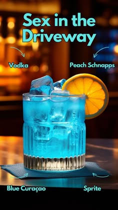 a blue drink with ice and an orange slice