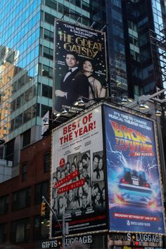 the back to the future movie billboards are in front of tall buildings and skyscrapers