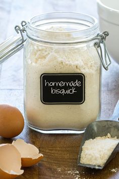 a glass jar filled with flour next to eggs