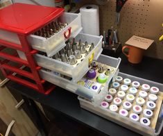 an assortment of crafting supplies sitting on a workbench with tools in it