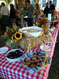 a table topped with lots of food on top of a red and white checkered table cloth