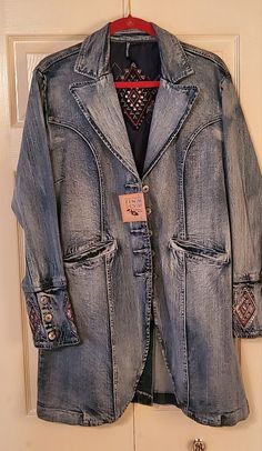 It's A Denim Long Jacket With Embroidery On The Cuffs And Back Of Jack.. Size Xl , But It Fits Like A Large. Very Beautiful Embroidery. Western Style Dark Wash Outerwear With Pockets, Western Denim Outerwear With Pockets, Medium Wash Outerwear For Rodeo In Fall, Western Style Denim Blue Jacket For Fall, Western Style Long Sleeve Denim Outerwear, Medium Wash Denim Outerwear For Rodeo, Western Long Sleeve Denim Outerwear, Spring Western Denim Outerwear, Western Style Medium Wash Outerwear For Spring