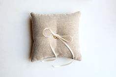 a pillow with a white ribbon tied to it