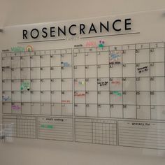 a wall mounted calendar with writing on it