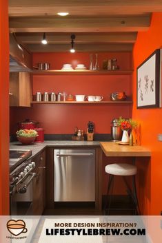 a kitchen with orange walls and stainless steel appliances