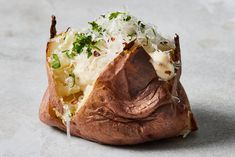 a baked potato with cheese and herbs on top