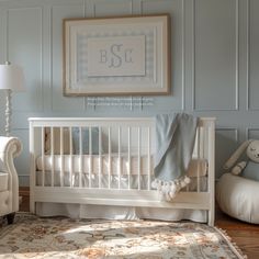 a baby's room with a white crib and blue walls