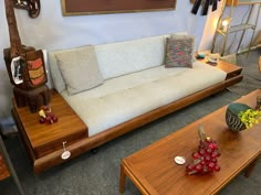 a living room filled with lots of furniture and decor on top of carpeted flooring