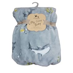 a blue baby blanket with a shark on it's back and the words, my cozy