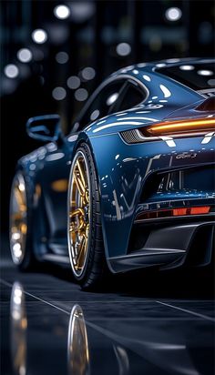 a blue sports car parked in front of a building at night with its lights on