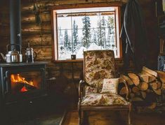 a chair sitting in front of a fire place next to a wooden burning stove top