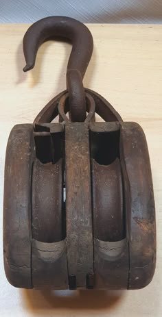 an old cast iron hook on a wooden table