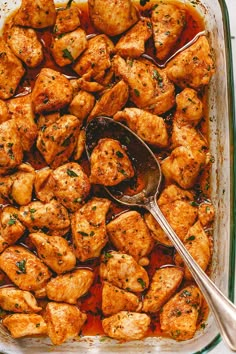 a casserole dish filled with chicken and sauce