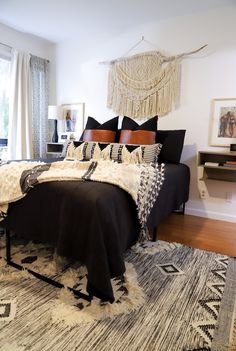 a bedroom with a bed, rugs and ceiling fan in it's center