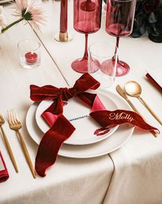 the table is set with red napkins, silverware and wine glasses for an elegant touch