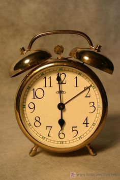 an alarm clock sitting on top of a table