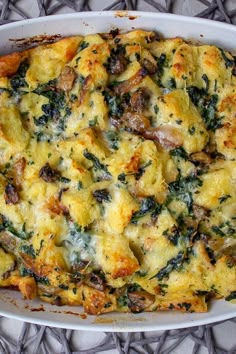 a casserole dish with mushrooms, spinach and cheese