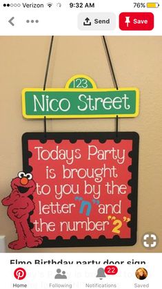 a sesame street sign hanging on the wall next to a toilet paper dispenser that says,'today is party to you by the letter m and the number? '