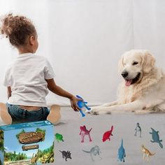 a toddler playing with toys and a dog