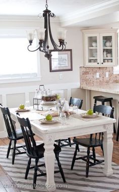 a white kitchen with painted table and chairs