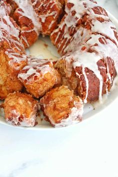 a white plate topped with donuts covered in icing