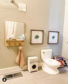 a bathroom with a toilet, sink and mirror