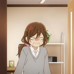 an anime character with long hair and glasses sitting in front of a computer desk, staring at the camera