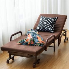 a brown chaise lounge chair with pillows on it