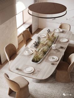 a dining room table with plates and place settings on it, surrounded by beige chairs