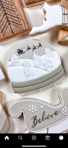 some cookies are laying on a table with snowflakes and santa's sleighs