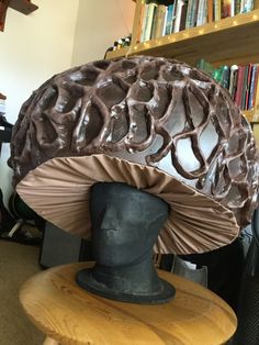 a sculpture of a human's head with a large brain on top of it