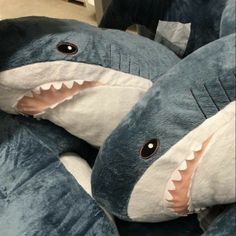 two stuffed sharks with their mouths open