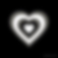 a white heart shaped object in the dark