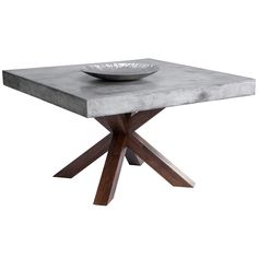 a concrete table with wooden legs and a bowl on top