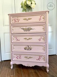 a pink dresser with flowers on it