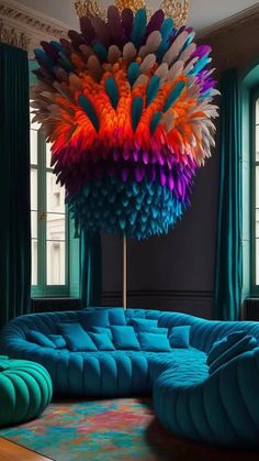 a colorful couch sitting under a chandelier in a living room