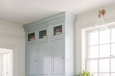 a kitchen with blue cabinets and white counter tops