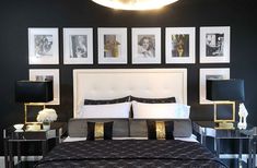 a black and white bedroom with pictures on the wall above the bed, along with two nightstands