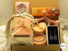 an open box containing candles, soaps and other items