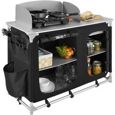 an outdoor cooking cart with food and utensils on it's shelves,