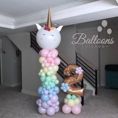 a balloon unicorn is standing in the middle of a room with balloons all around it