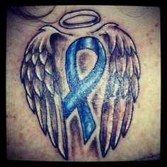 a blue ribbon with angel wings on the back of a woman's shoulder and chest