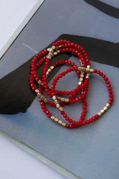 Treat yourself to our delightful Roses are Red Bracelet! This five pack set of bracelets is the perfect treat for any occasion. Each gold and red beaded stretch bracelet is sure to bring a sparkle to your style! It's the perfect bling to add a pop to any outfit. Red And White Beaded Bracelet, Red Stackable Bracelets With Round Beads, Trendy Red Stackable Beaded Bracelets, Trendy Red Stackable Jewelry, Trendy Red Stackable Bracelets, Trendy Red Stretch Bracelet With Round Beads, Trendy Red Round Beads Stretch Bracelet, Red Beaded Jewelry, White Beaded Bracelet